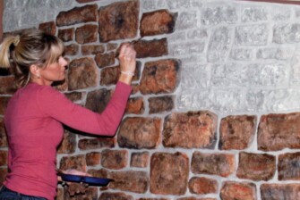 teresa painting fake bricks on wall